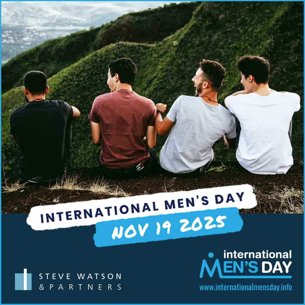 Image of four men sitting on the edge of a mountain, laughing together