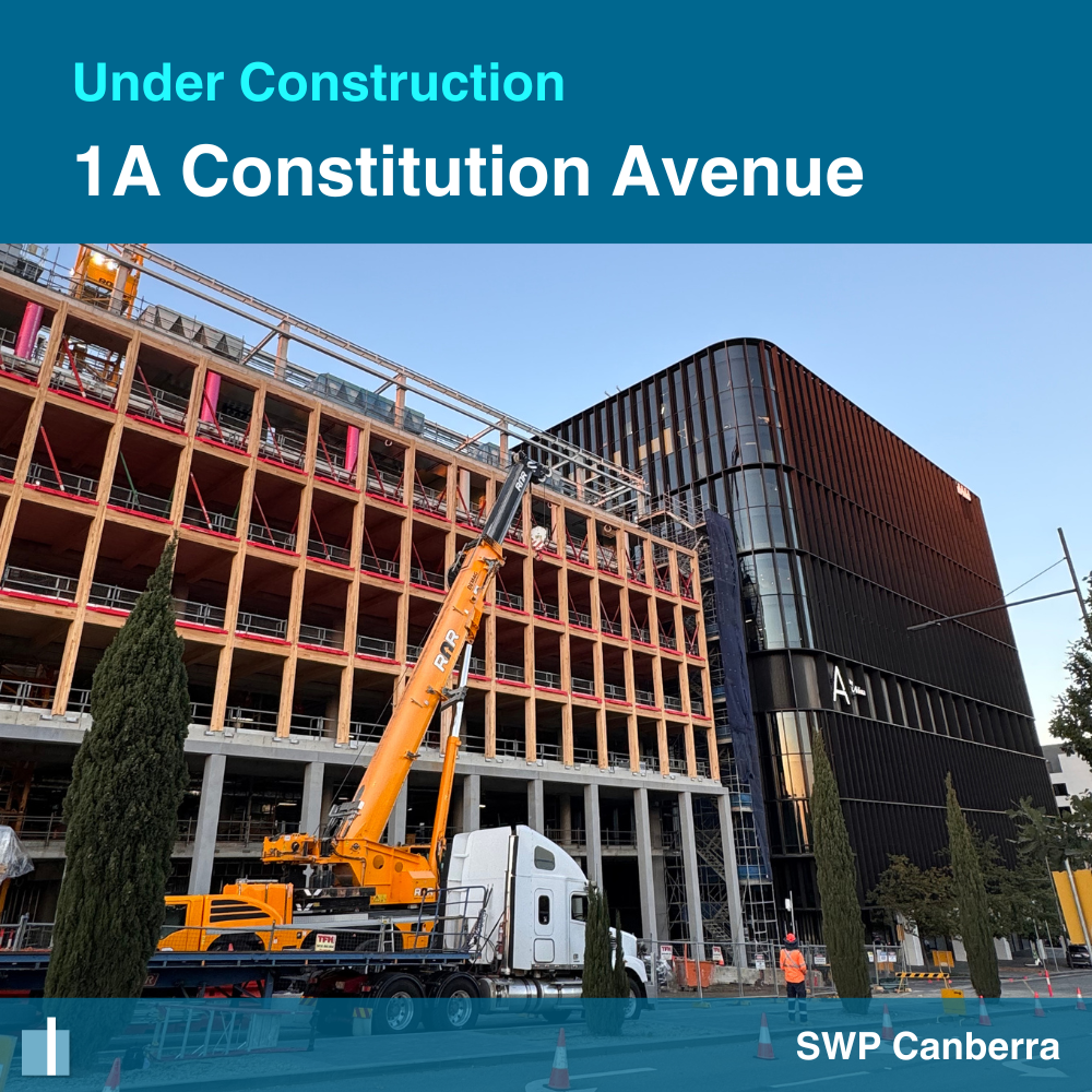 Construction progress at 1A Constitution Avenue in Canberra featuring a hybrid timber commercial building structure and crane on site.
