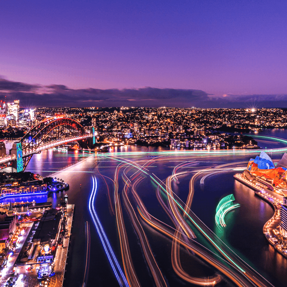 Image of the Sydney skyline and Sydney Harbour Bridge being lit up